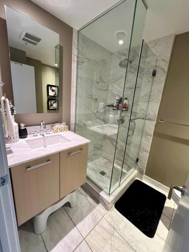 a bathroom with a shower and a sink at Century Park Condo Oasis in Edmonton
