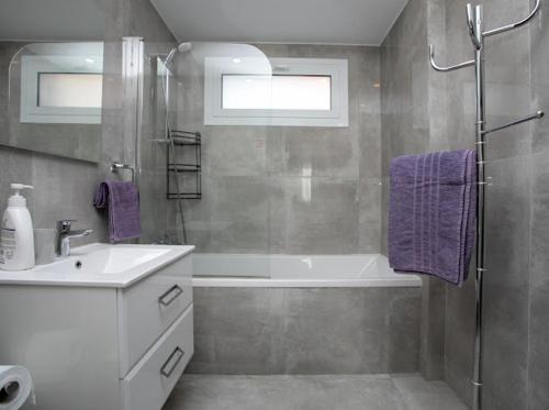 a bathroom with a sink and a tub and a shower at Villa Valendra in Peyia