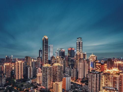 a city skyline at night with many tall buildings at m58 Sky Sunset Hotel in Chongqing