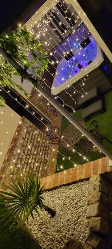 a patio with a table with lights on it at Gîte & Spa in Barly