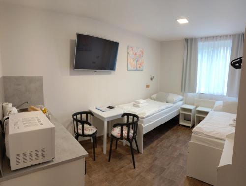 a hospital room with a bed and a table with chairs at Apartmány U zámku in Český Krumlov