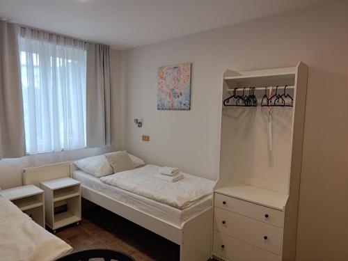 a small bedroom with a bed and a window at Apartmány U zámku in Český Krumlov
