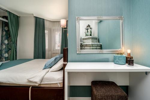 a bedroom with a bed and a mirror at French House in Belgrade