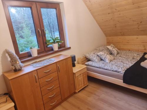 a bedroom with a bed and a window at Domek na Czerwonej Górce in Uście Gorlickie