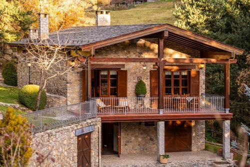 a house with a large deck on top of it at Mountain Lodge Can Campaner in Escaldes-Engordany