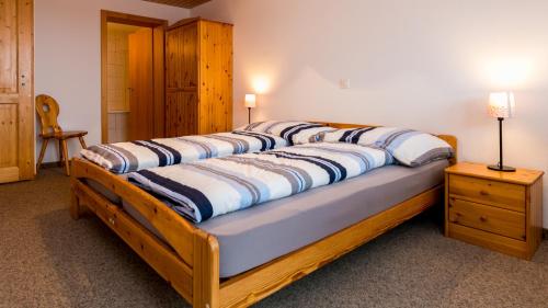 a large bed with a wooden frame in a bedroom at Christiania in Riederalp