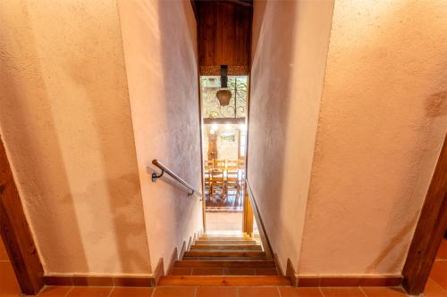 a hallway with a stairway leading to a dining room at Mountain Lodge Can Campaner in Escaldes-Engordany
