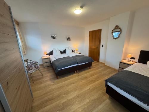 a bedroom with two beds and a television in it at Gästehaus Garber in Stumm