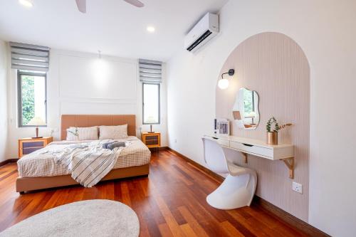 a bedroom with a bed and a desk and a mirror at Bungalow Putrajaya 15pax w Private Pool Gathering in Putrajaya