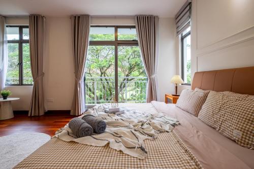a large bed in a room with a large window at Bungalow Putrajaya 15pax w Private Pool Gathering in Putrajaya