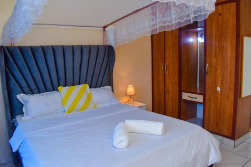 a bedroom with a bed with two towels on it at Bamburi Phase 4, near Naivas Supermarket in Mombasa