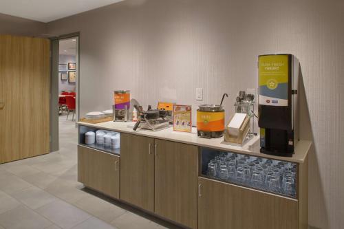 eine Küche mit einer Theke mit Getränken und einer Kaffeemaschine in der Unterkunft Home2 Suites By Hilton Little Rock Midtown Medical Center in Little Rock
