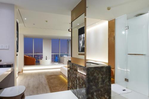 a large bathroom with a view of a city at m58 Sky Sunset Hotel in Chongqing