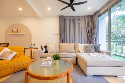 a living room with a couch and a table at Bungalow Putrajaya 15pax w Private Pool Gathering in Putrajaya