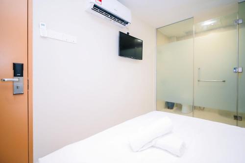 a bathroom with a mirror and a tv at Swing & Pillows - Times Square, Bukit Bintang in Kuala Lumpur