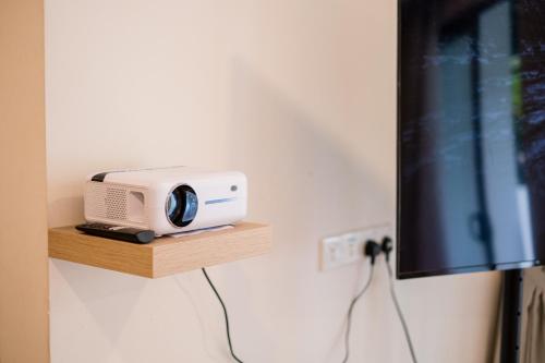 a radio sitting on a shelf next to a tv at Bungalow Putrajaya 15pax w Private Pool Gathering in Putrajaya