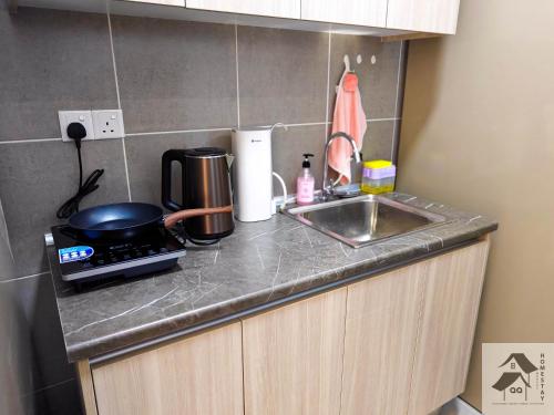 a kitchen counter with a stove and a sink at Nilai-YouthCity-Uitm-Gembox-Lovely Stay-2r2b in Nilai
