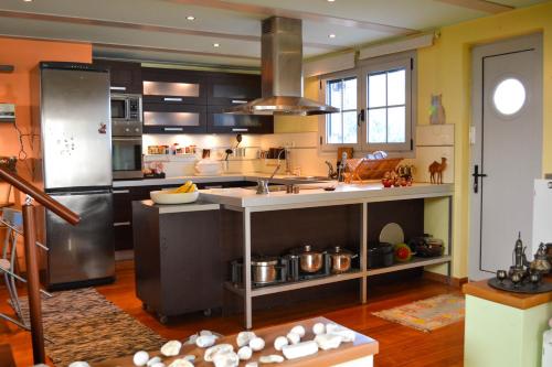 a large kitchen with a large island in the middle at The Grand Beach House in Karistos