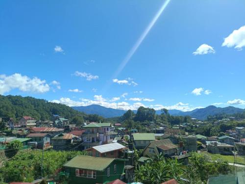 a city with a rainbow in the sky at FAMILY UNIT in SAGADA in Sagada