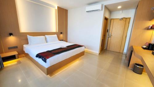 a bedroom with a bed and a television in it at Silver Mounts Hotel in Phnom Penh