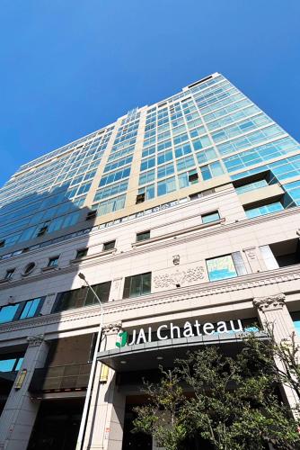 a tall building with a sign in front of it at JAI Château Hotels & Hostels in Tainan