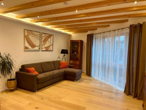 a living room with a couch and a large window at Gartenhaus Luise in Dresden