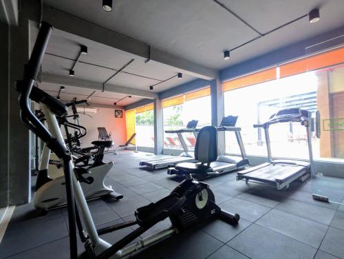 a gym with several tread machines in a room at MAXONE Dumai in Dumai