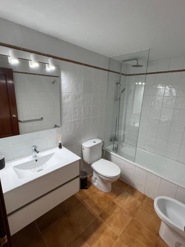 a bathroom with a sink and a toilet and a mirror at Apartment Sonrisa - spacious two bedroom apartment in Costa Teguise