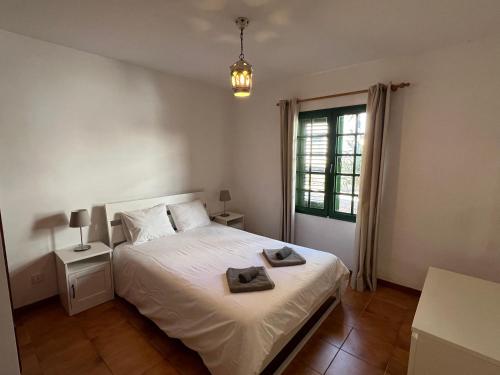 a bedroom with a bed with two towels on it at Apartment Sonrisa - spacious two bedroom apartment in Costa Teguise