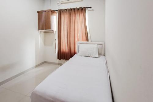 Ένα ή περισσότερα κρεβάτια σε δωμάτιο στο Wisma Al Iman Syariah 25 Mitra RedDoorz