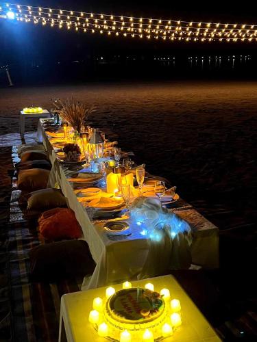a long table with glasses and lights on it at Puerto Silanguin Beach Resort in Subic