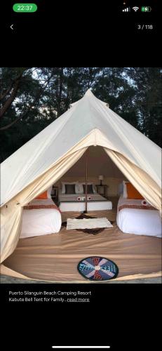 a tent with a bunch of beds in it at Puerto Silanguin Beach Resort in Subic