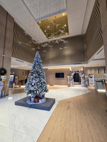 a christmas tree in the middle of a shopping mall at K Avenue Kota Kinabalu by Merveille - Sabah in Donggongon