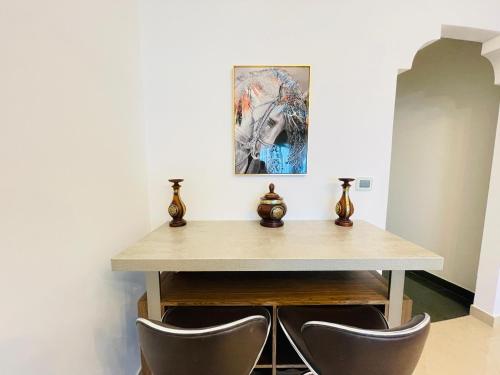a dining room with a wooden table and chairs at Al Hamra Residence in Ras al Khaimah