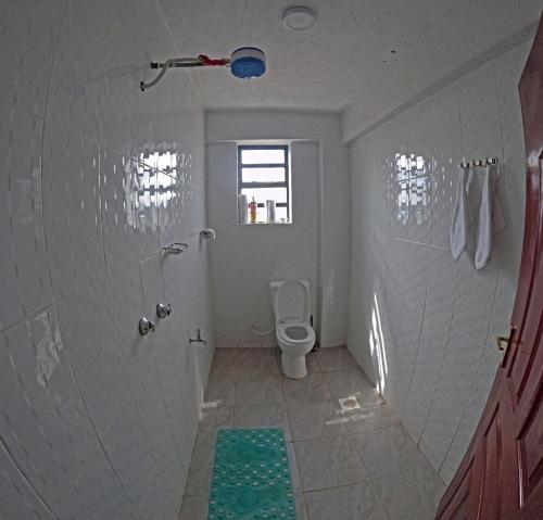 a bathroom with a shower and a toilet in it at Brightstay furnished apartments in Nairobi