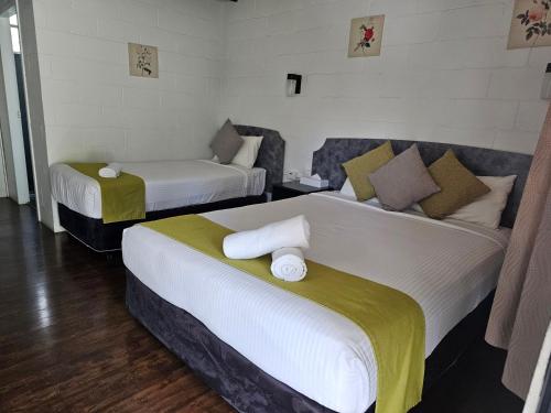 a hotel room with two beds in a room at Azalea Motel in Coonabarabran
