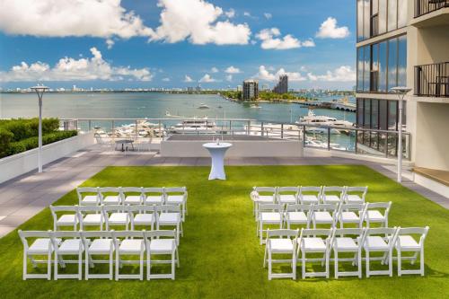 a balcony with white chairs and a view of the water at Miami Marriott Biscayne Bay in Miami
