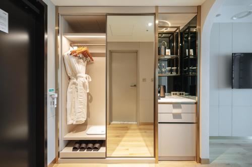 a dressing room with a mirror and a sink at Eliena Hotel Seoul Gangnam in Seoul