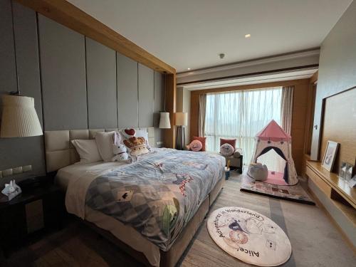 a bedroom with a bed and a play tent at Pullman Haining in Haining