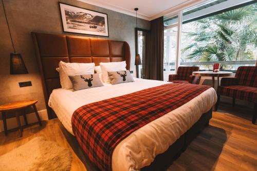 a bedroom with a large bed and a large window at Badhotel Rockanje in Rockanje