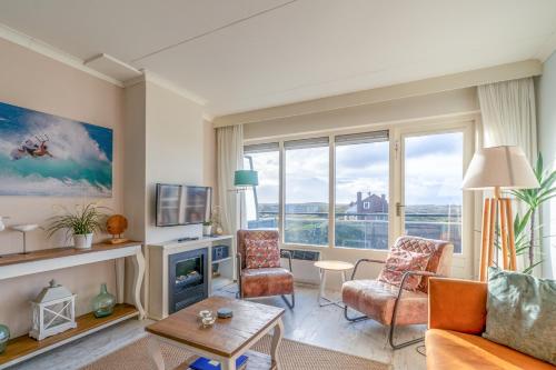 a living room with a couch and chairs at Appartementencomplex Juliana 148 in De Koog