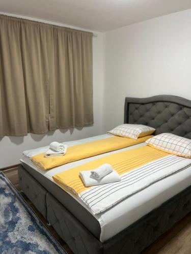 a large bed with two towels on it in a bedroom at Villa Casa de Dina in Bihać