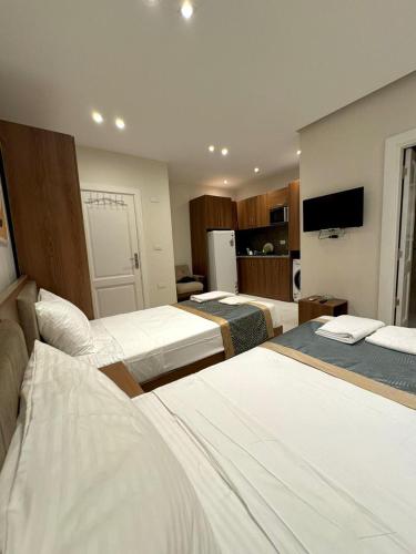a hotel room with two beds and a tv at October Square in 6th Of October