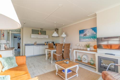 a living room with a couch and a table at Appartementencomplex Juliana 148 in De Koog