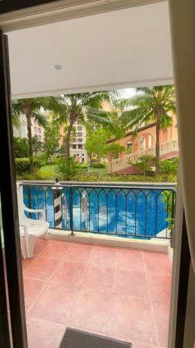 a view of the pool from the balcony of a house at Venetian Signature Pattaya by รมิตา in Jomtien Beach
