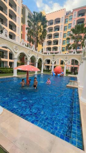 a group of people in the swimming pool at a resort at Venetian Signature Pattaya by รมิตา in Jomtien Beach