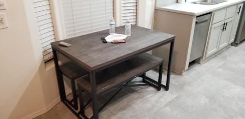 a wooden table in a kitchen with a sink at 038 Dine & Unwind Tiny Home near Grand Canyon South Rim in Valle
