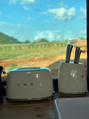 two toasters sitting on a table in a car at Tiny Escape Charlotte in Pak Chong