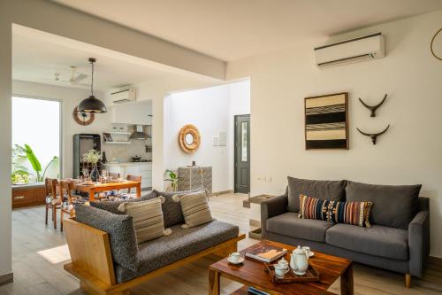 a living room with a couch and a table at La Olalian 2 & 3 BHK Designer Villas Near Anjuna Beach with Private Pool & Sun Deck & Garden in Anjuna