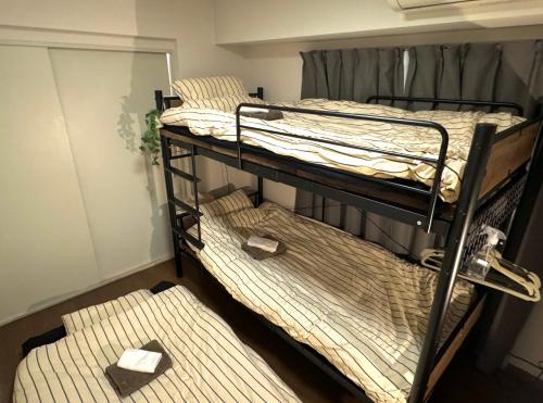 Postel nebo postele na pokoji v ubytování tsubaki house
